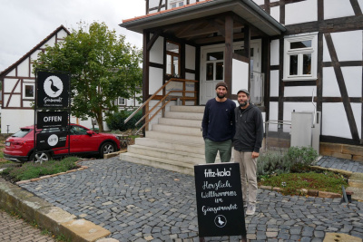 Die Brüder Carsten und Samuel Waldeck stehen vor einem Haus.